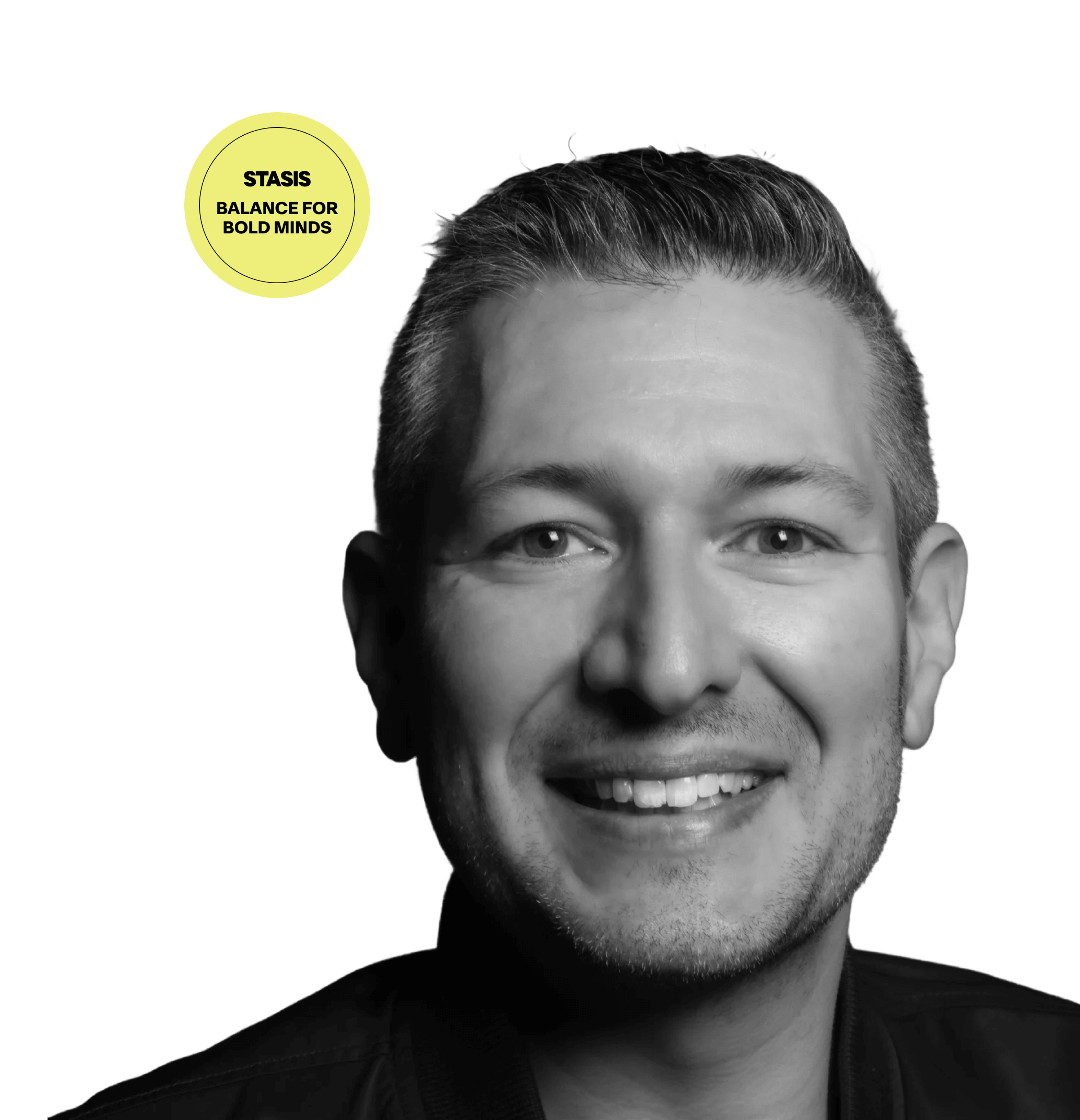 Black and white portrait of a smiling man with a green background.