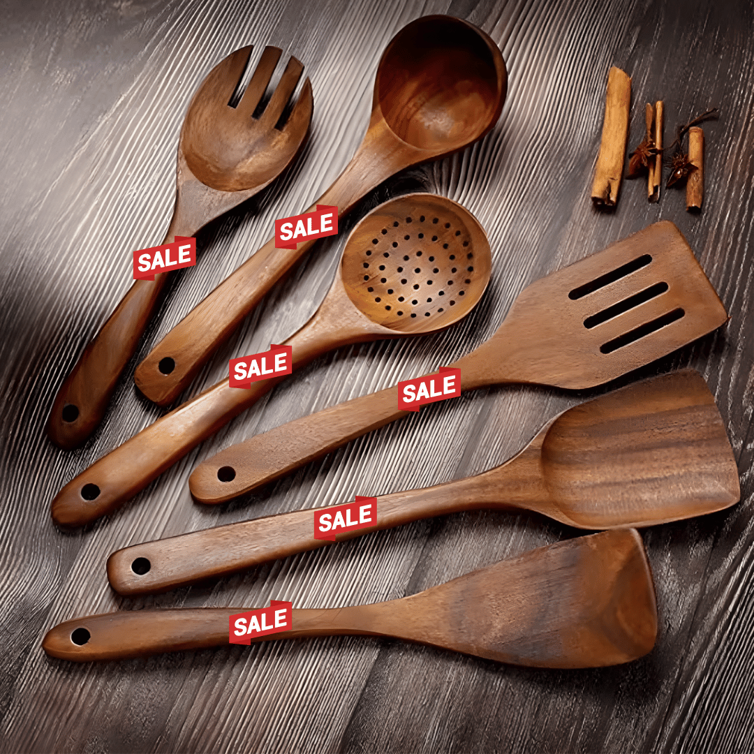 Wooden kitchen utensils with sale tags arranged on a dark wooden surface.