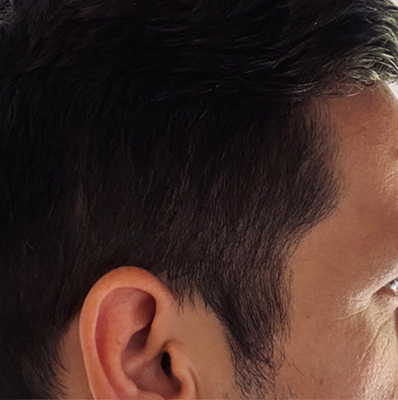 Close-up of a person's ear and side of the head.