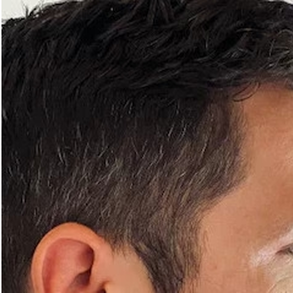 Close-up of a person's ear and hair.