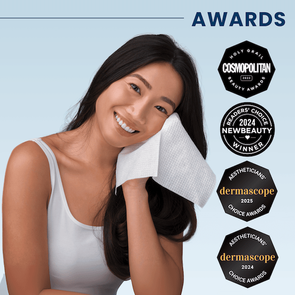 Smiling woman holding a cloth to her face, with award badges beside her.