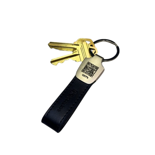 Two gold keys on a black leather keychain with a QR code.