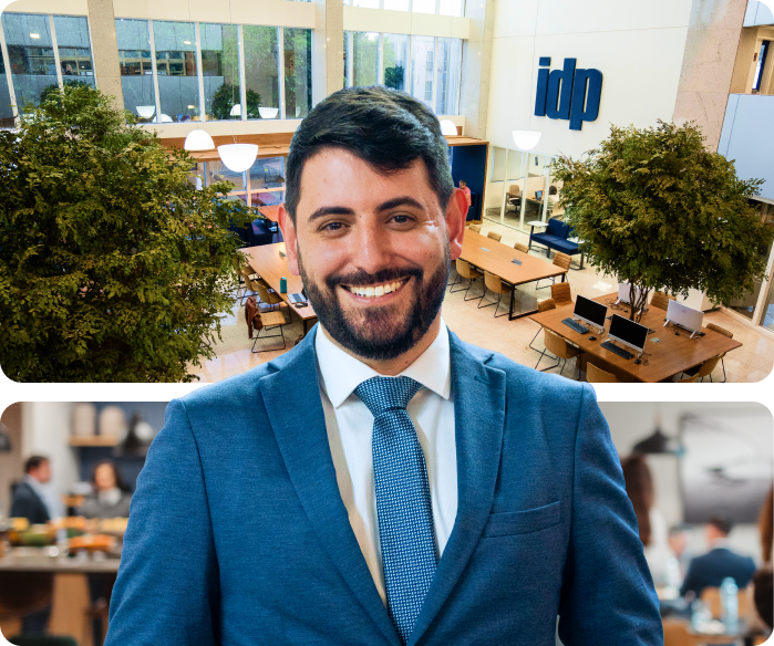A smiling man in a blue suit and tie, superimposed over a modern office lobby with an 'idp' logo.