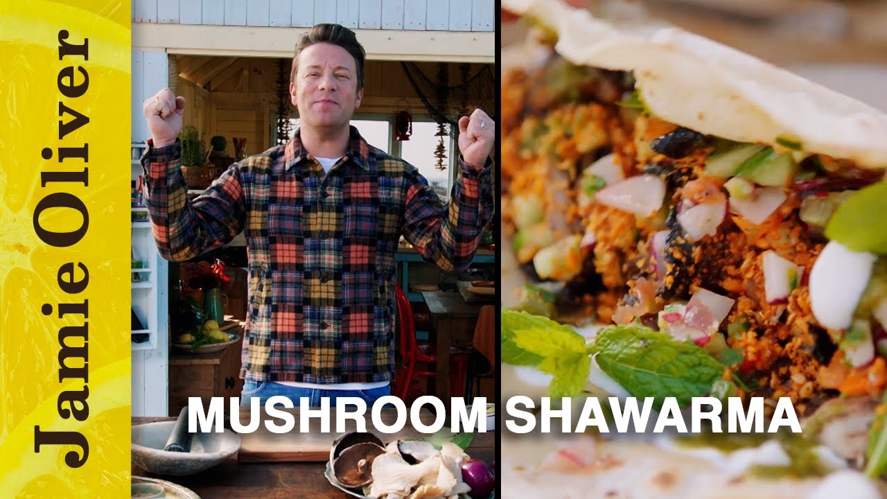 Person in plaid shirt beside mushroom shawarma sandwich.