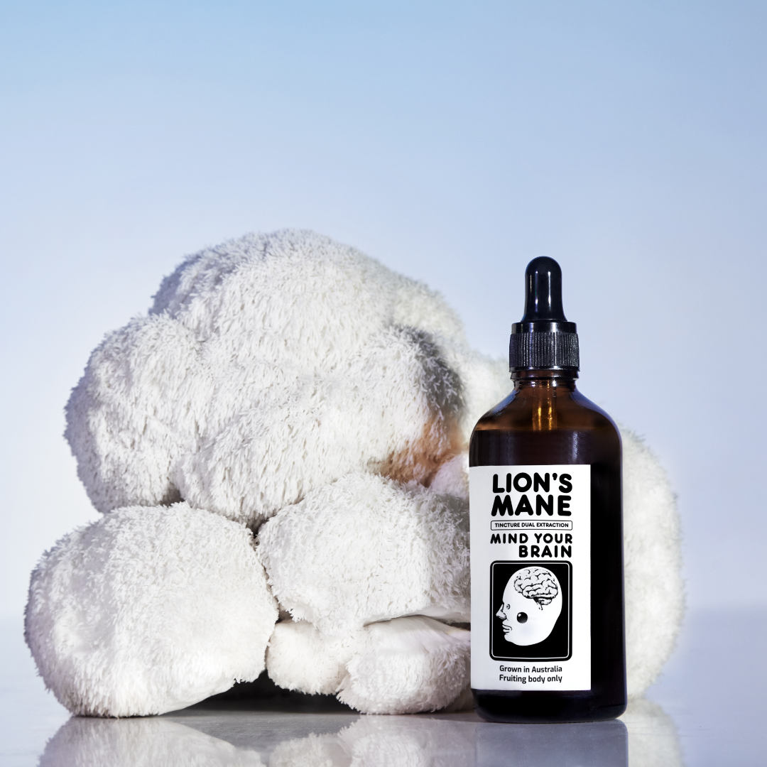 Brown bottle labeled 'Lion's Mane' next to a fluffy white object.