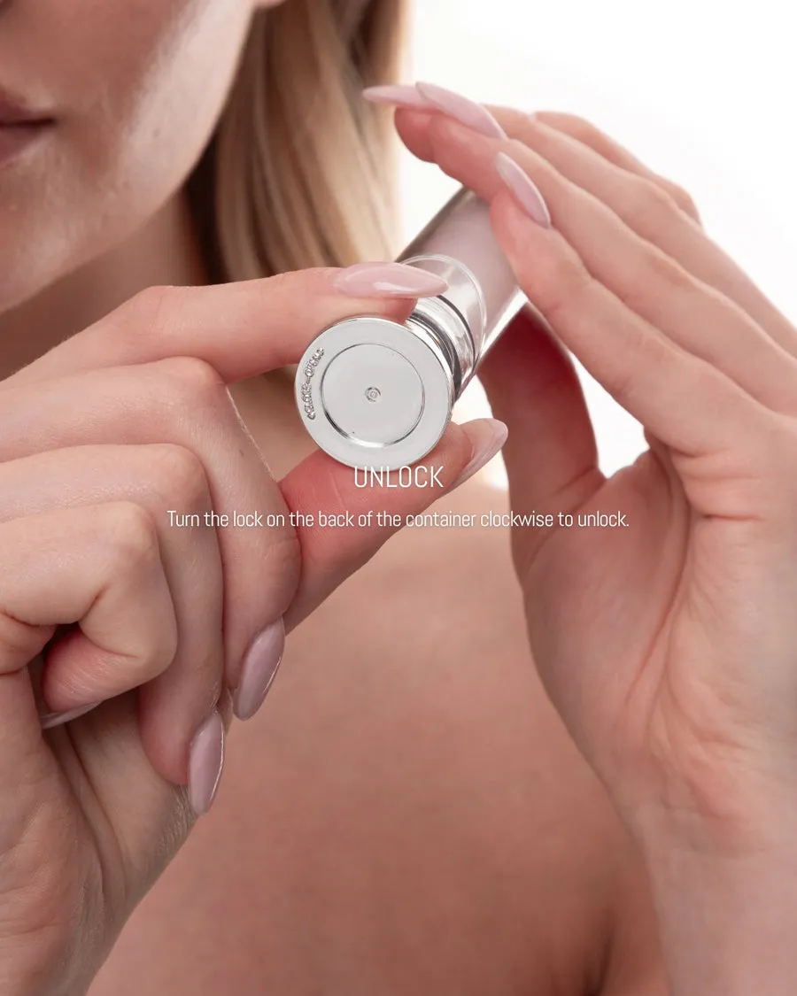 A close-up of a woman's hands with manicured nails holding a cosmetic container to show the locking mechanism.