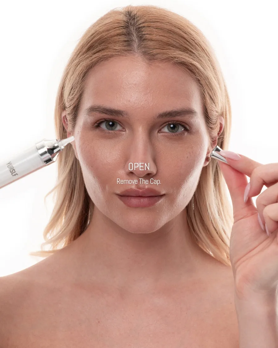 A woman removes the silver cap from a white, pen-like cosmetic applicator, demonstrating how to open it.