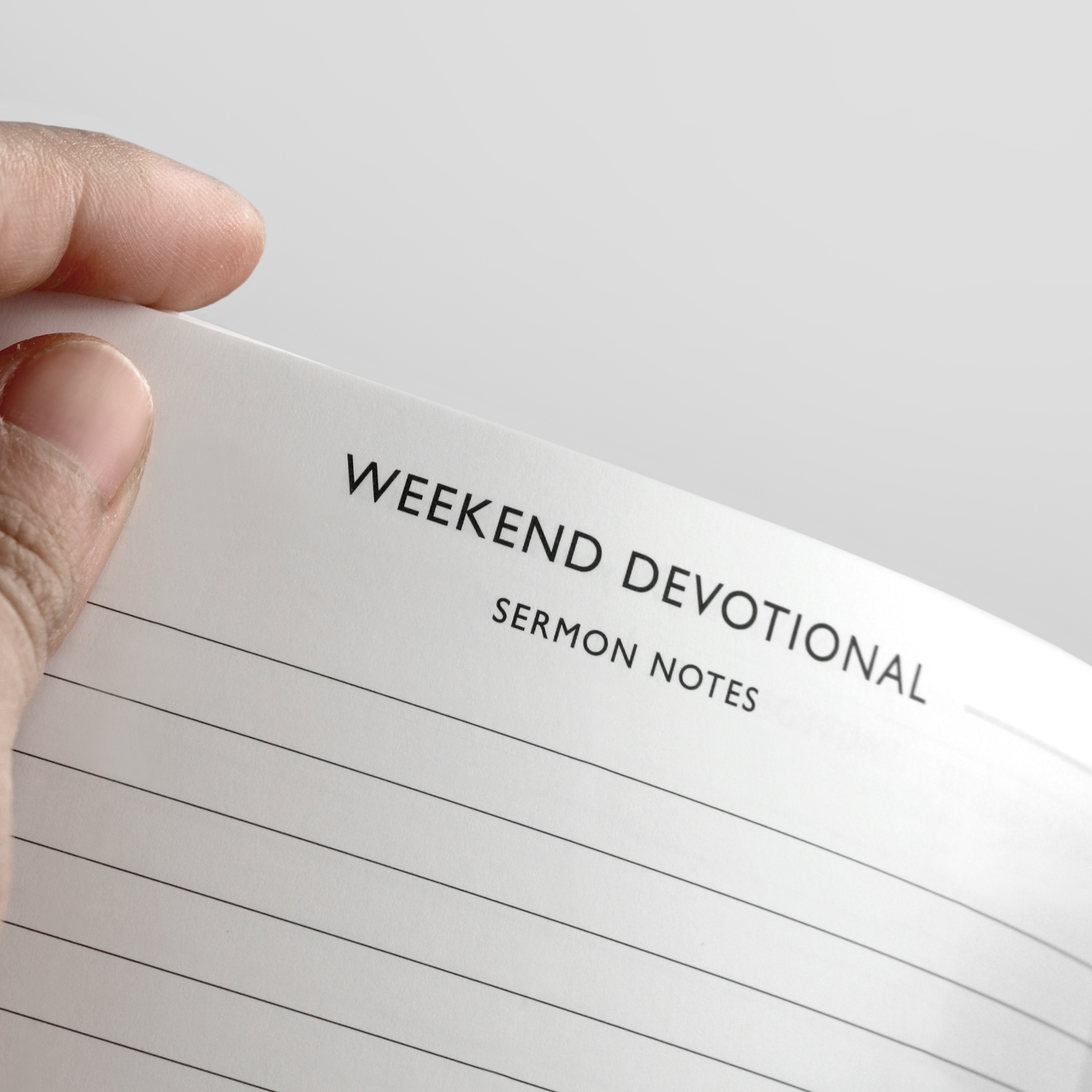 A hand holds open a notebook to a page titled 'Weekend Devotional Sermon Notes'.