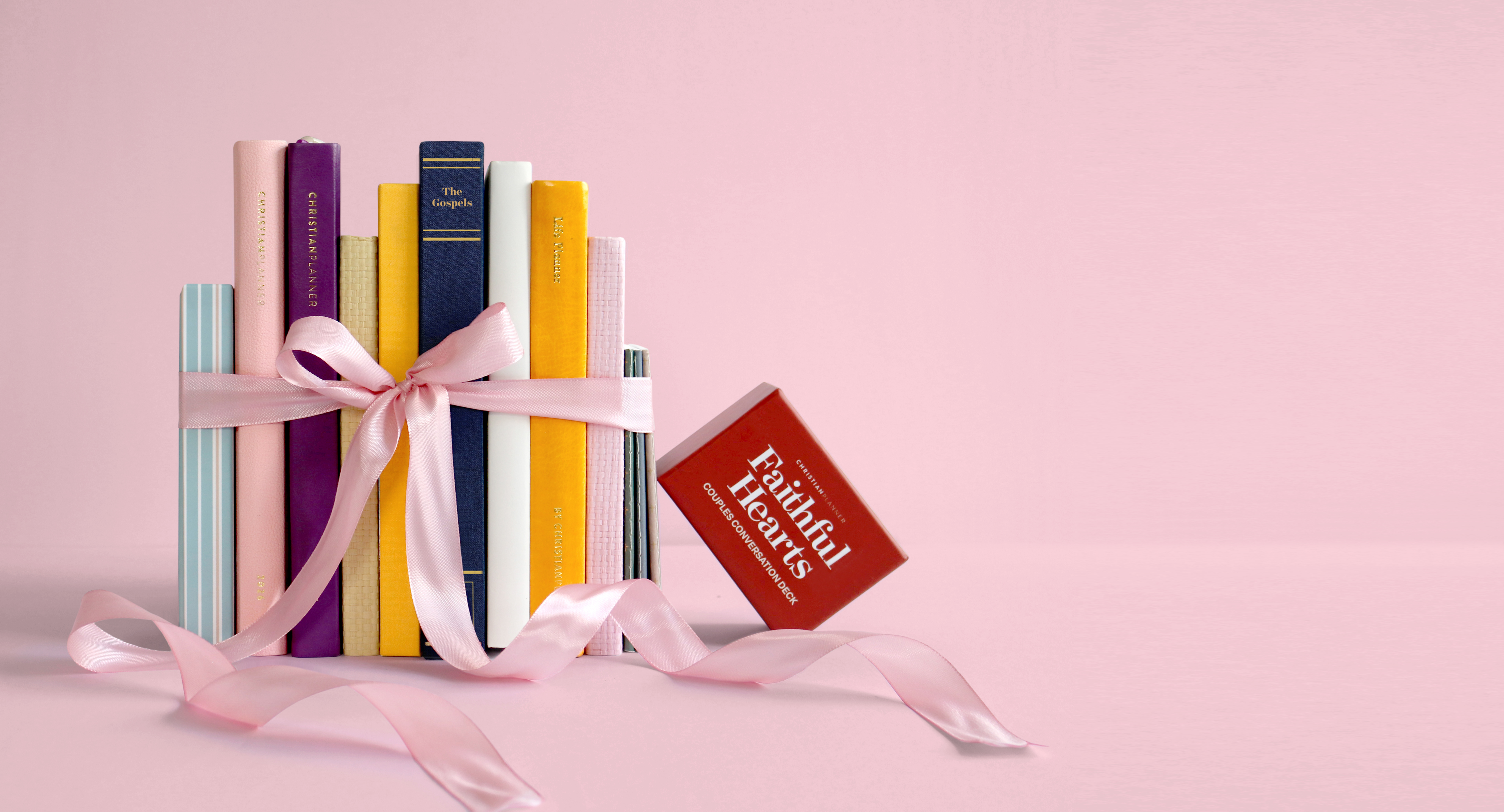 Japanese snack box with tea, snacks, and utensils against a red background.