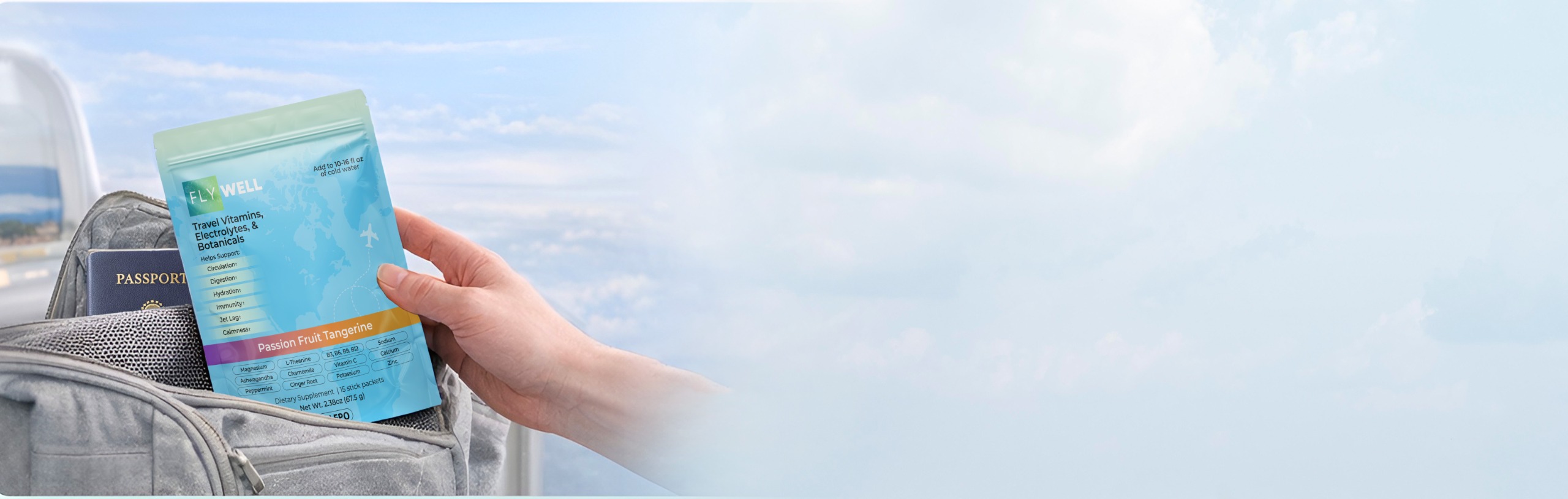 A hand holds a pouch of Fly Well travel vitamins over a travel bag containing a passport.