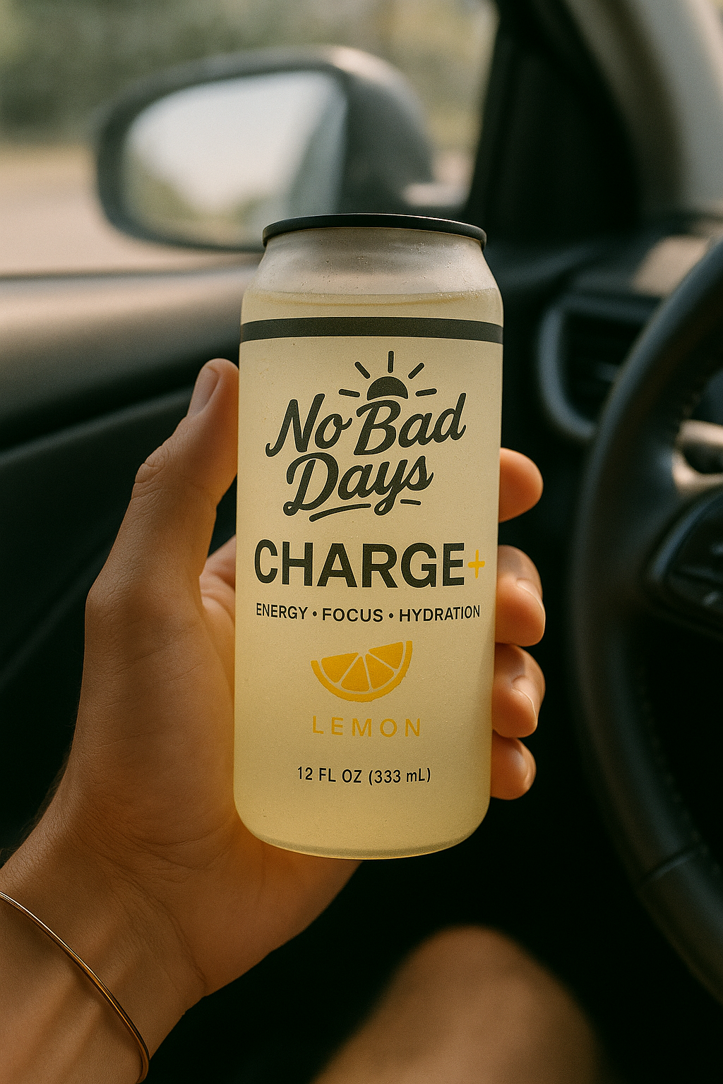 Hand holding a lemon-flavored energy drink can inside a car.