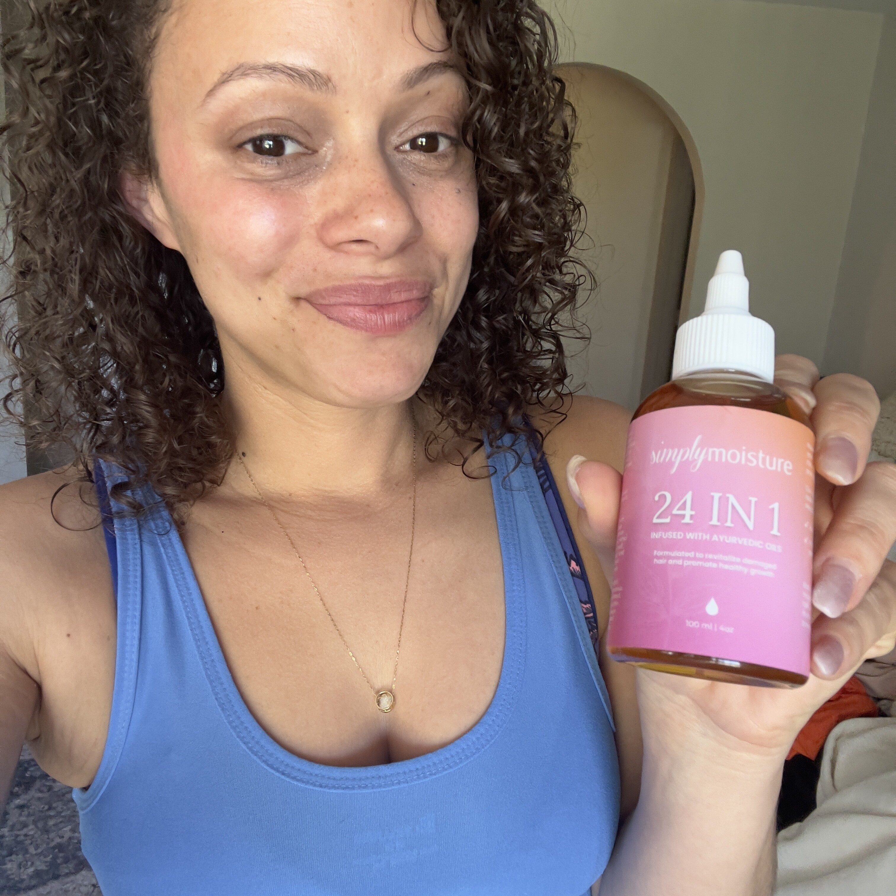 Person holding a bottle labeled '24 IN 1' with a pink label.