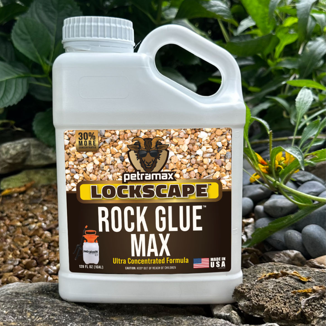 A white jug of Petramax Lockscape Rock Glue Max resting on a rock in a garden.