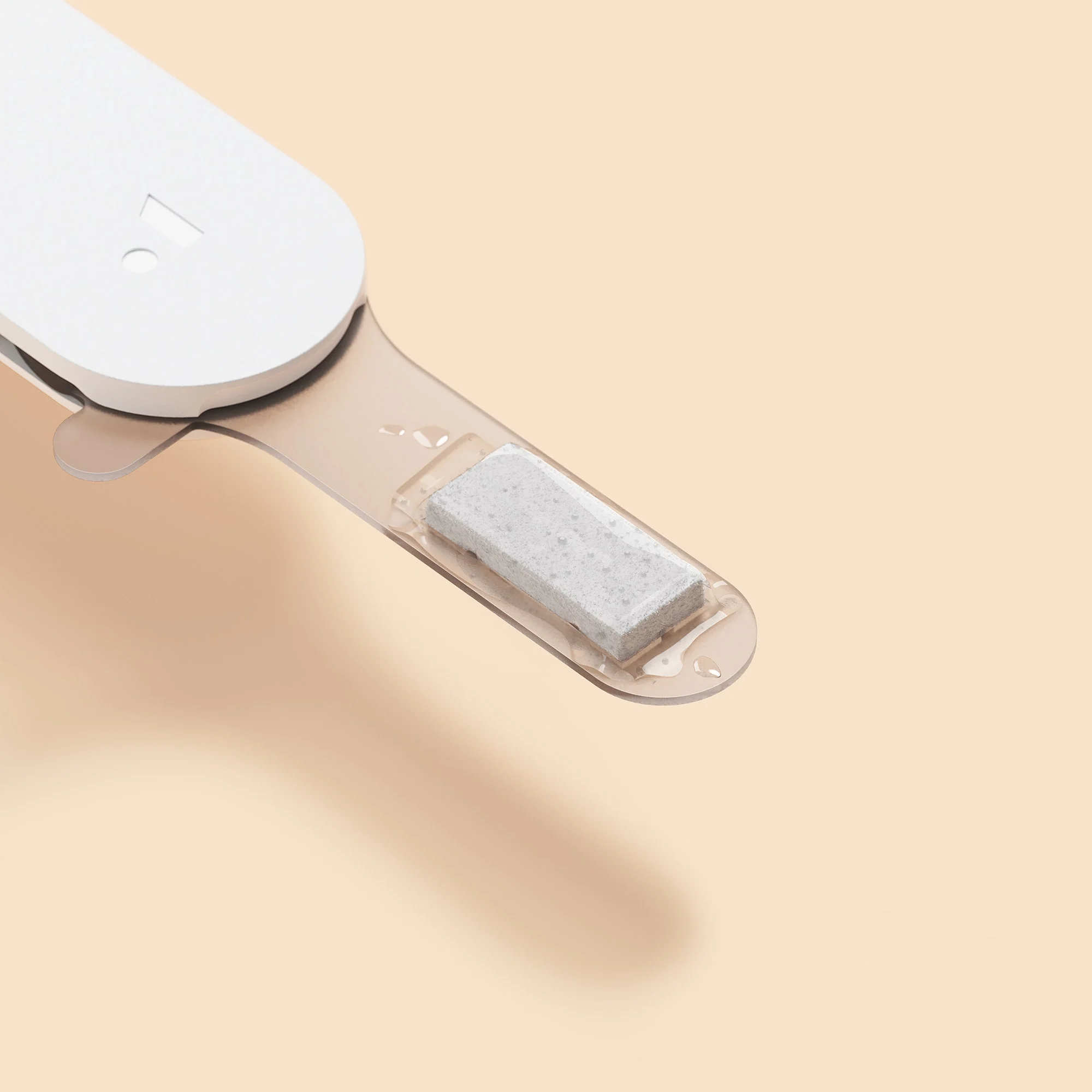 Close-up of a white device with a rectangular component on a beige background.