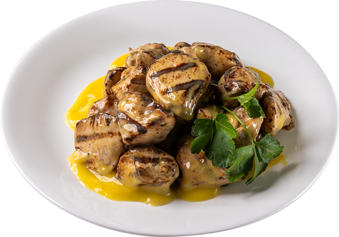 Grilled mushrooms with sauce and parsley on a white plate.