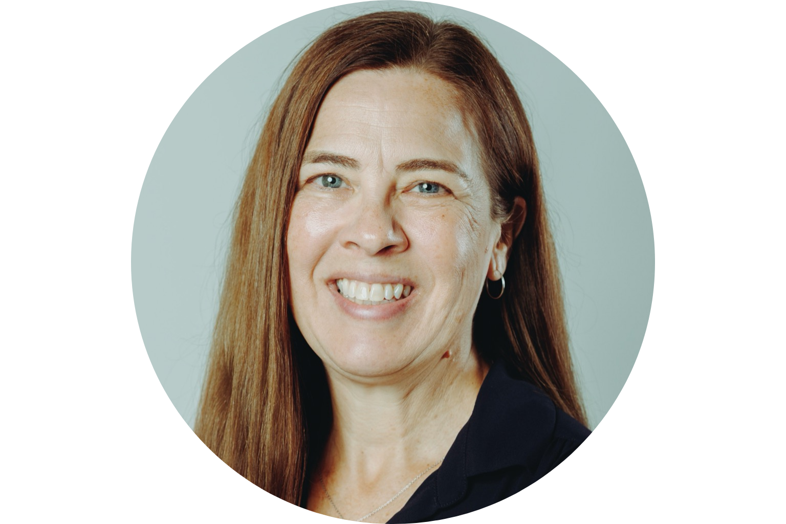 Smiling woman with long brown hair and hoop earrings.