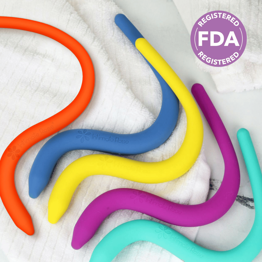 Colorful silicone pelvic wands on a white towel with FDA registered badge.