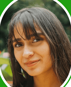 Portrait of a woman with long hair and bangs, smiling slightly.