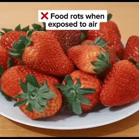 Plate of strawberries with text warning about food rotting when exposed to air.