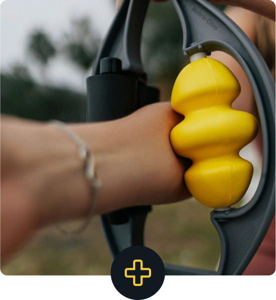 Hand using a handheld arm massager with yellow rollers.
