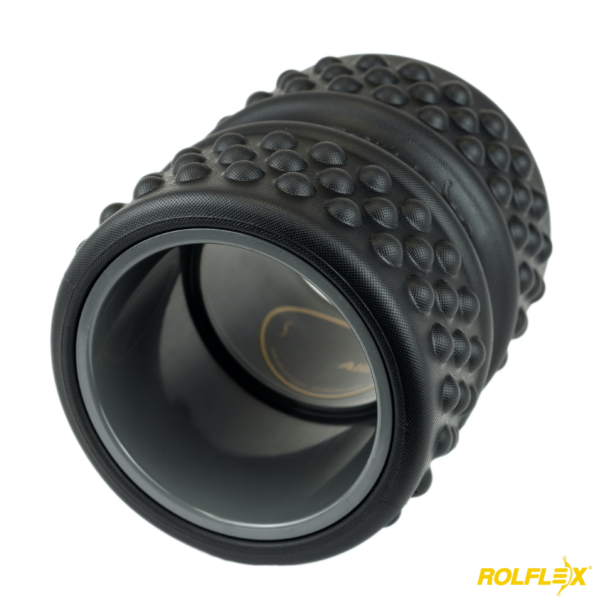 A black, bumpy massage roller with a hollow grey core, shown at an angle on a white background.