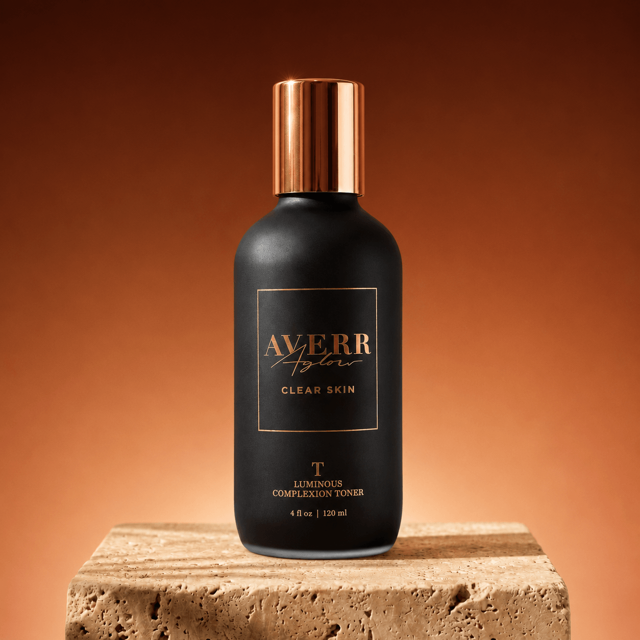A black bottle of Averr Aglow skin toner with a copper cap, sitting on a stone block.