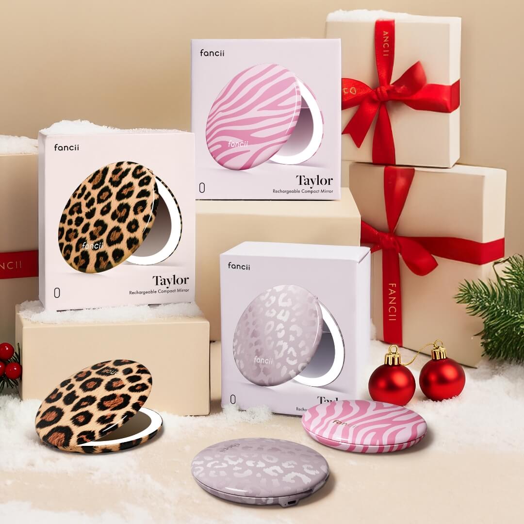 Compact mirrors with animal print designs surrounded by wrapped gifts and ornaments.