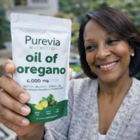 A smiling woman holds up a pouch of Purevia Nutrition oil of oregano.