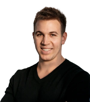 Smiling person in a black shirt against a plain background.