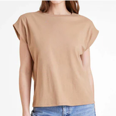 Person wearing a beige t-shirt and blue jeans against a white background.