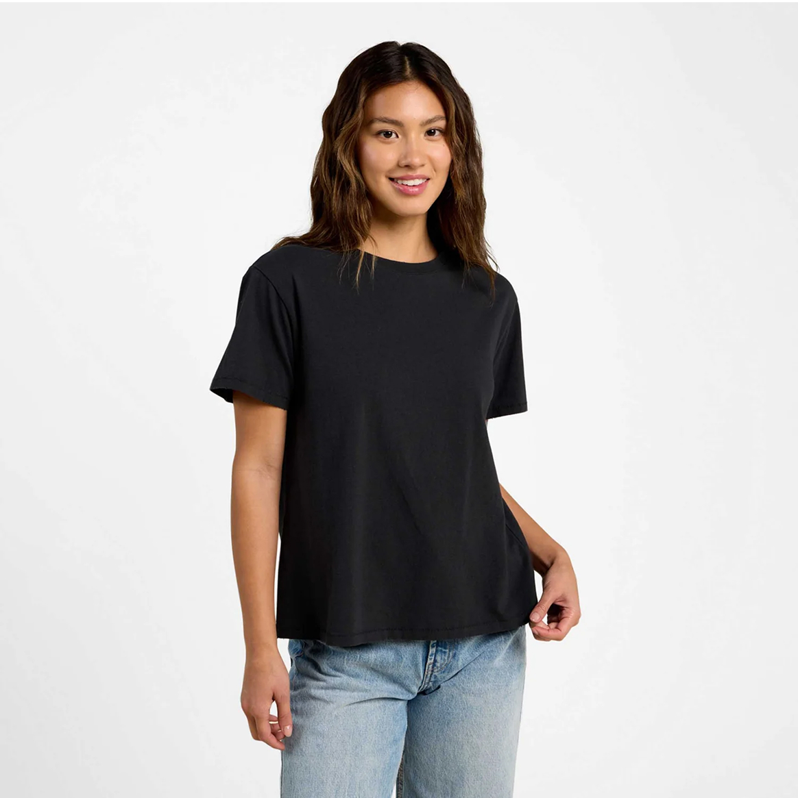 Person wearing a black t-shirt and jeans against a plain background.