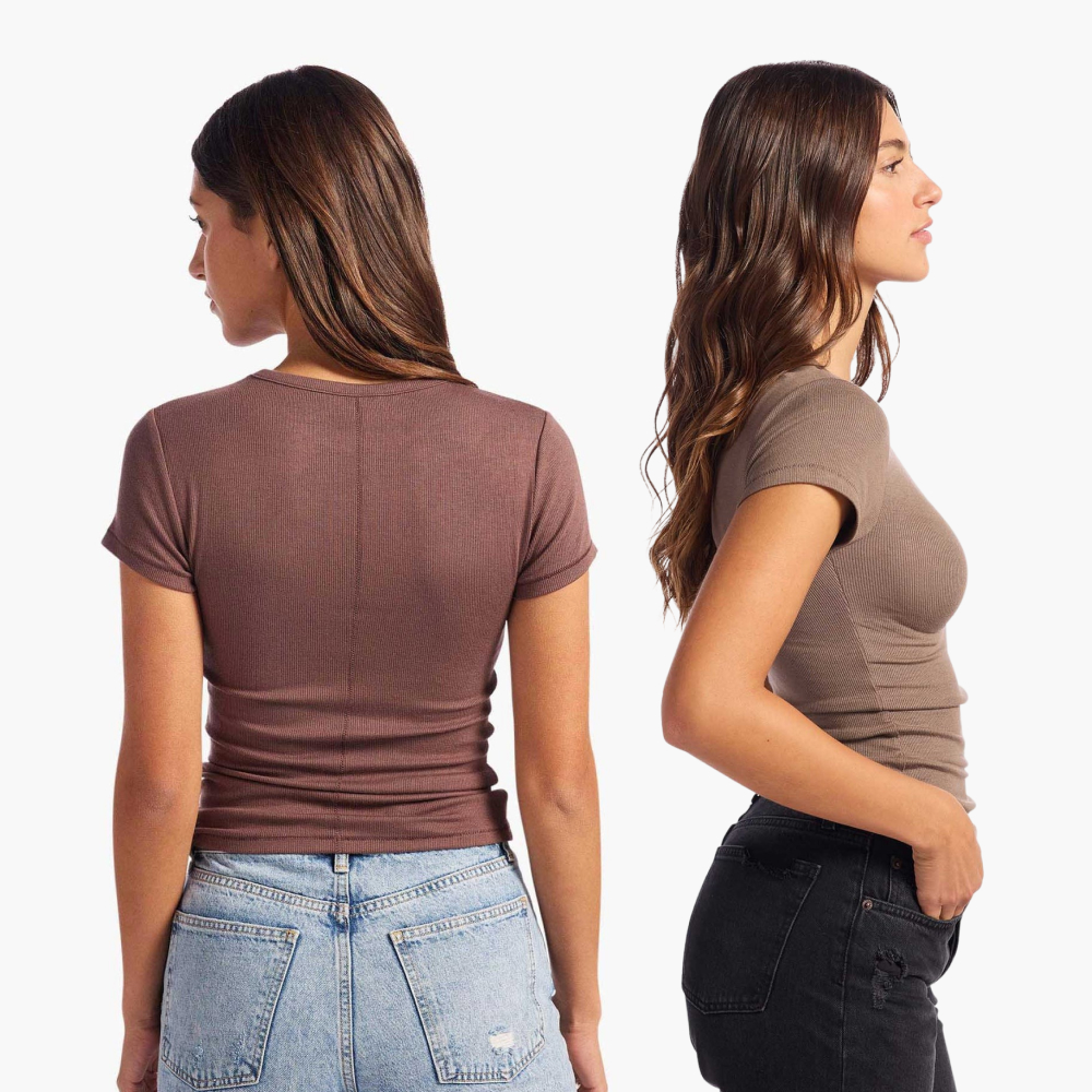 Two women in brown tops, one facing back, the other in profile.