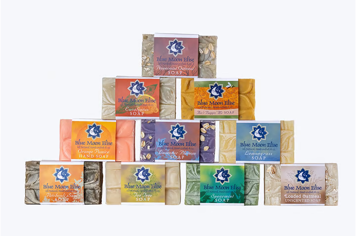 A pyramid of colorful soap bars with various labels.