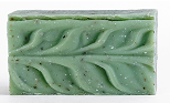 Green soap bar with leaf patterns and speckles.
