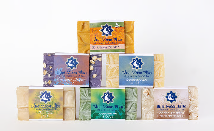 Stack of six Blue Moon Elise soap bars in various colors.