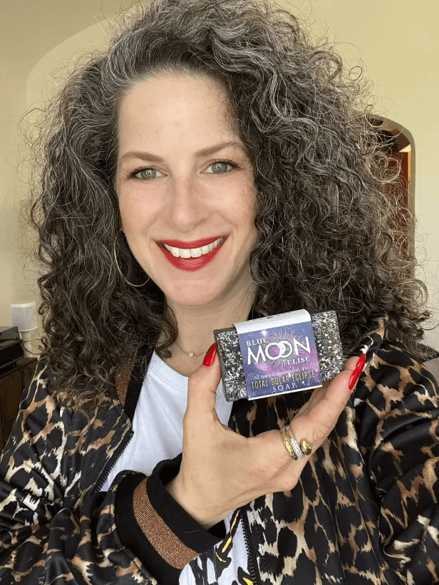 Person holding a bar of soap labeled 'Blue Moon Total Solar Eclipse.'