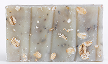 A bar of soap with oats and herbs embedded in it.