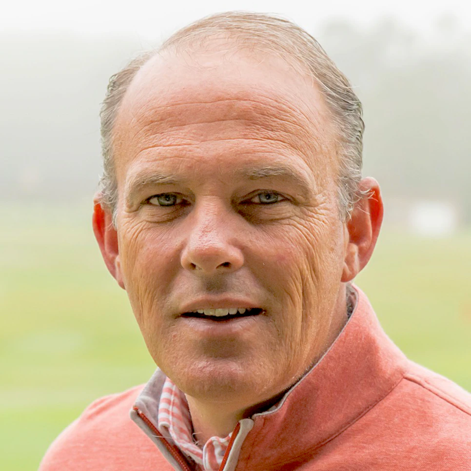 Person wearing a pink jacket, outdoors on a foggy day.
