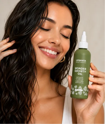 A smiling woman with dark wavy hair holds a green bottle of Lebanta Wonder Growth Oil.