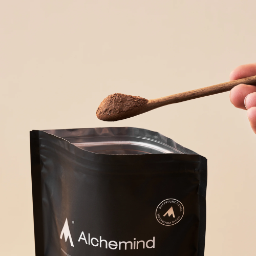 Spoon with powder above a black Alchemind bag.