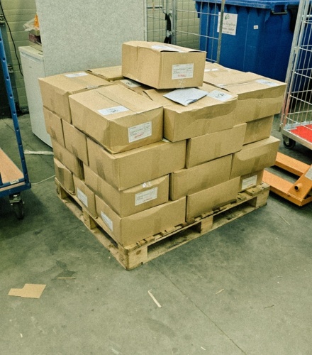 boxes with stock on pallet in warehouse