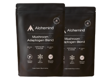 Two black Alchemind mushroom blend pouches with white text and logos.