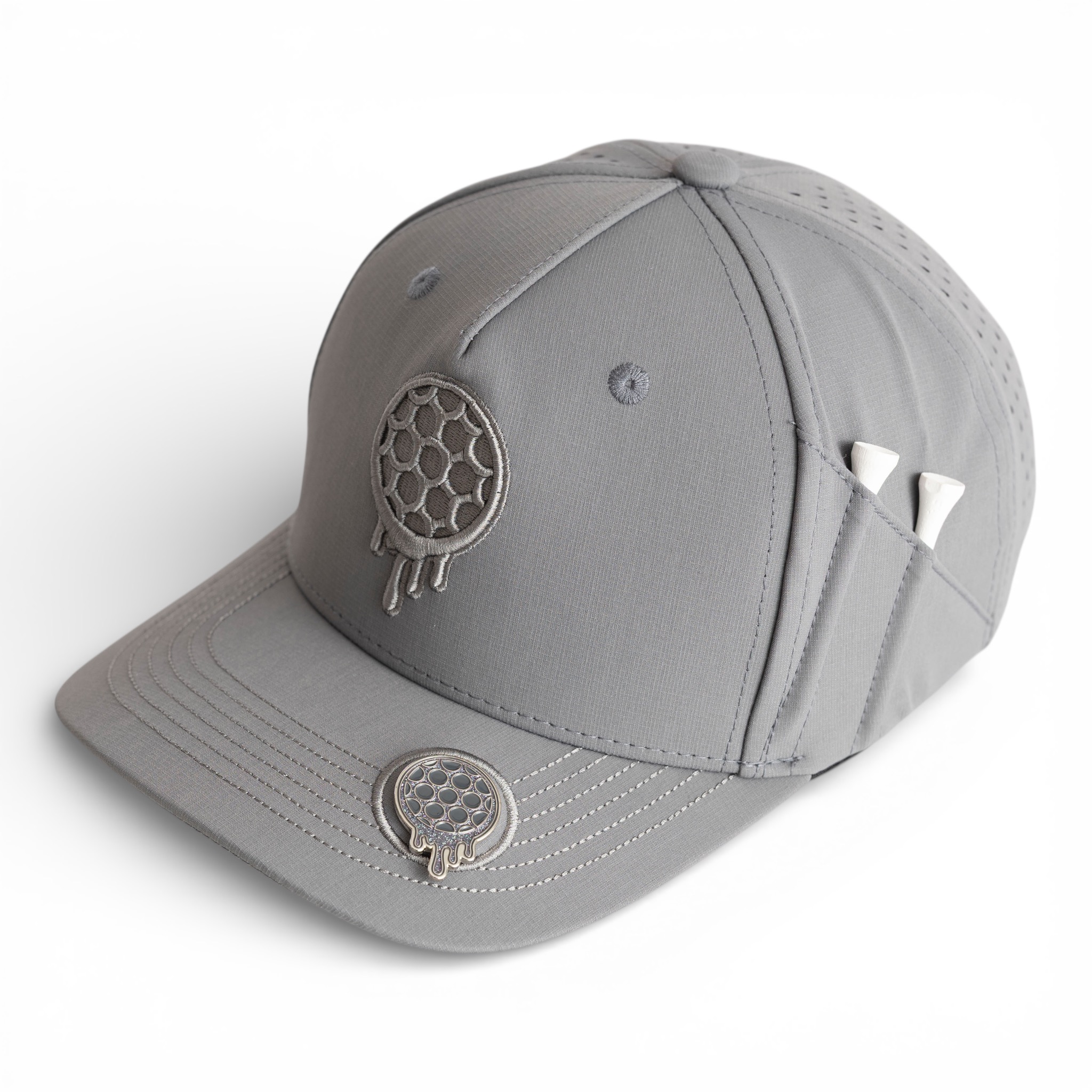A gray golf hat with a dripping golf ball logo, a ball marker, and a side pocket holding tees.