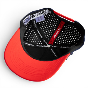 The inside of a black baseball cap with a red brim, showing a white star pattern lining.