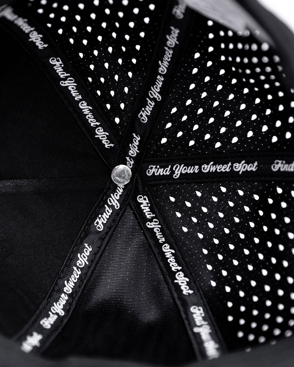 Interior view of a black hat with white lettering and dotted pattern.