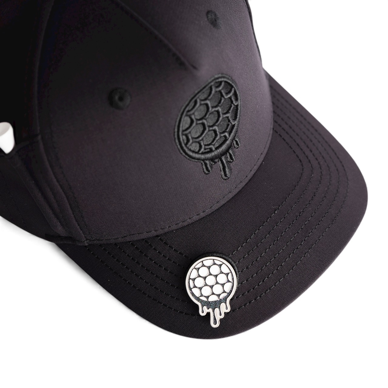 Black cap with textured pattern and circular embroidered logo on the brim.