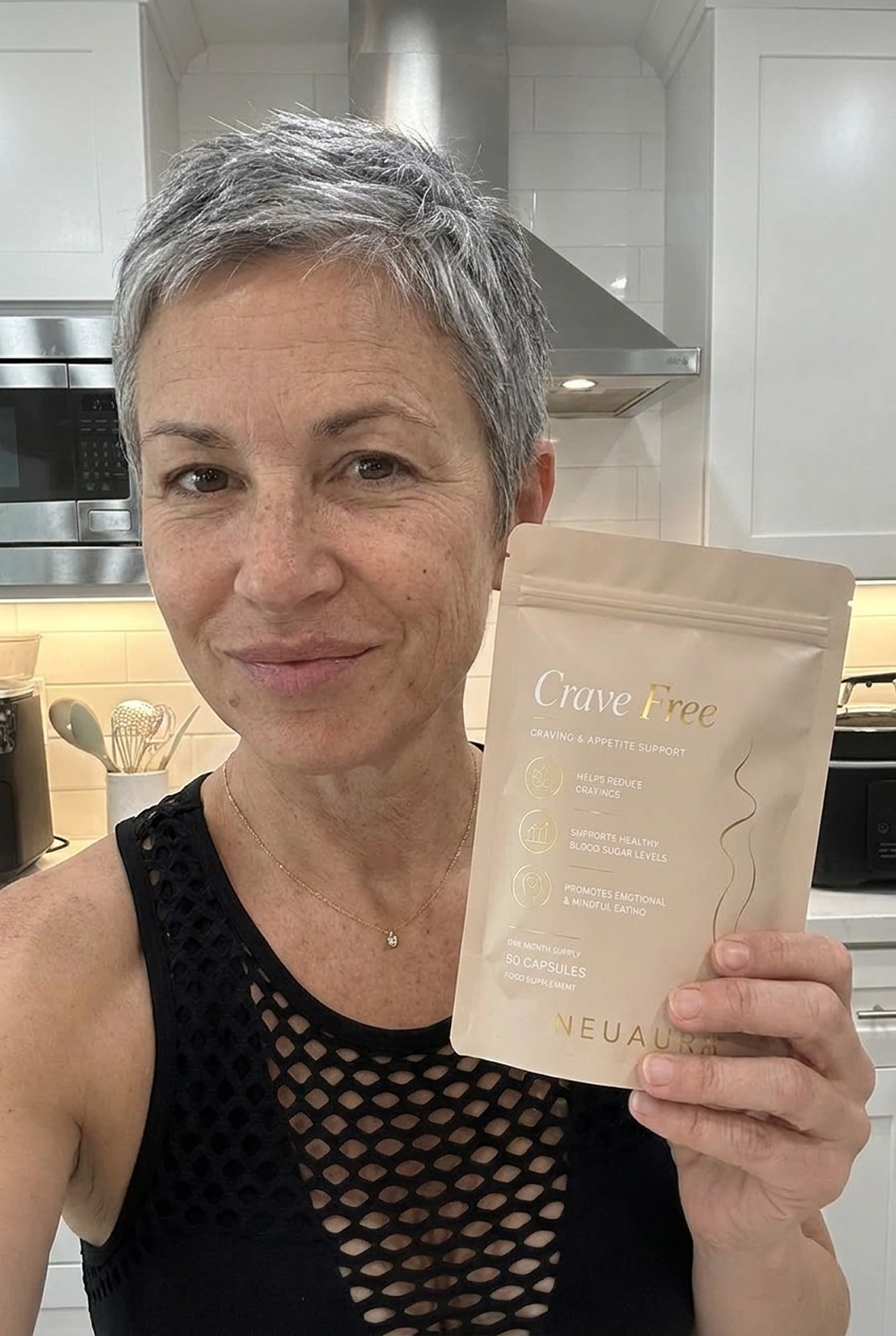 A woman in athletic wear holds two capsules and a glass of water next to a pouch of Crave Free supplements.