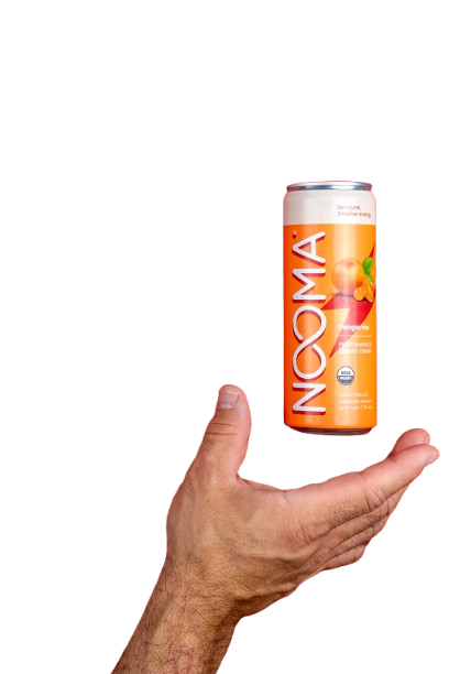 Hand holding an orange NOOMA drink can against a black background.