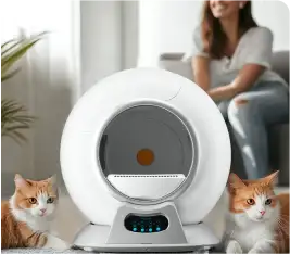 A futuristic litter box surrounded by two cats, with a woman in the background.