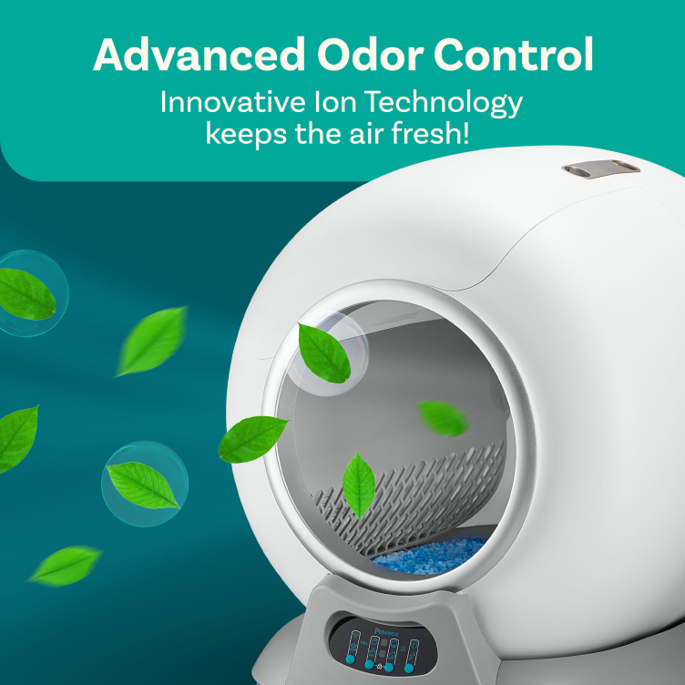 A white, modern automatic cat litter box with illustrative green leaves floating around it to represent freshness.